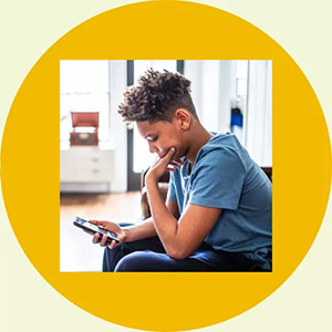 Kid looking sad on his phone