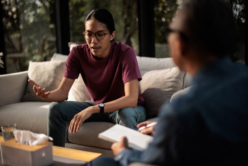 Young man talking to his therapist