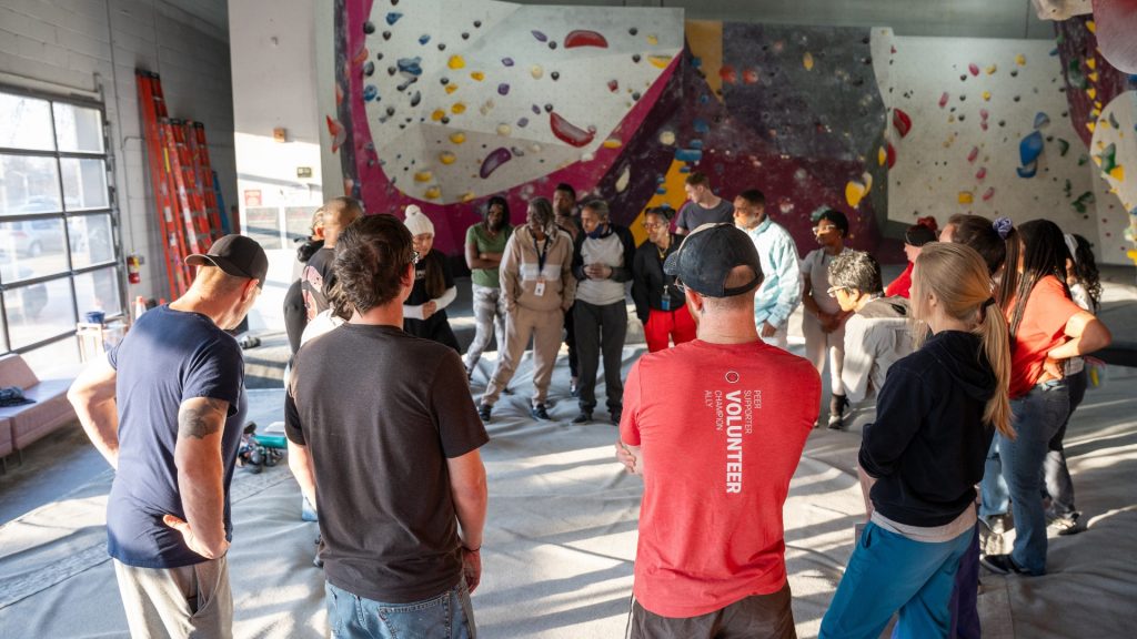 People rock climbing indoors