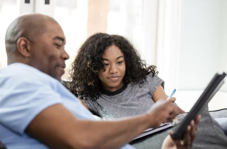 Father and daughter looking at job applications