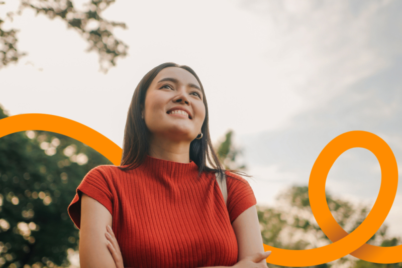 Young woman smiling outside