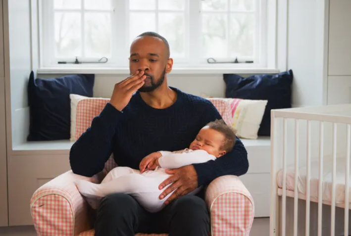 Father holding her infant child