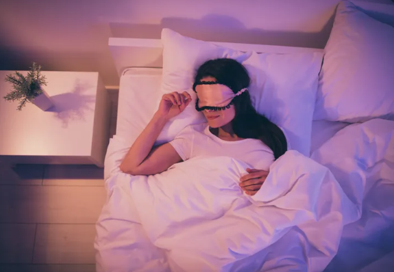Woman sleeping with a sleep mask