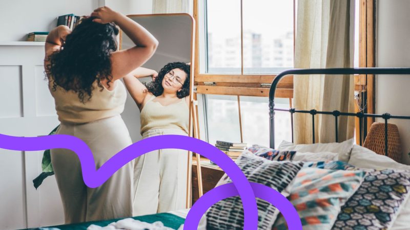 Young woman looking at herself in the mirror
