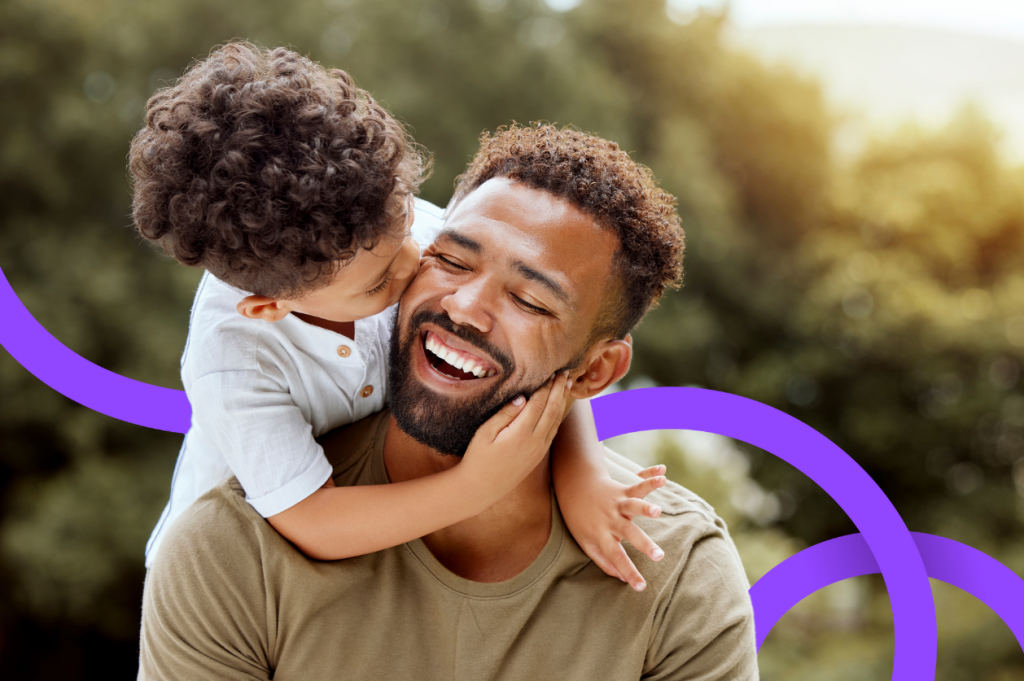 Young boy kissing his father