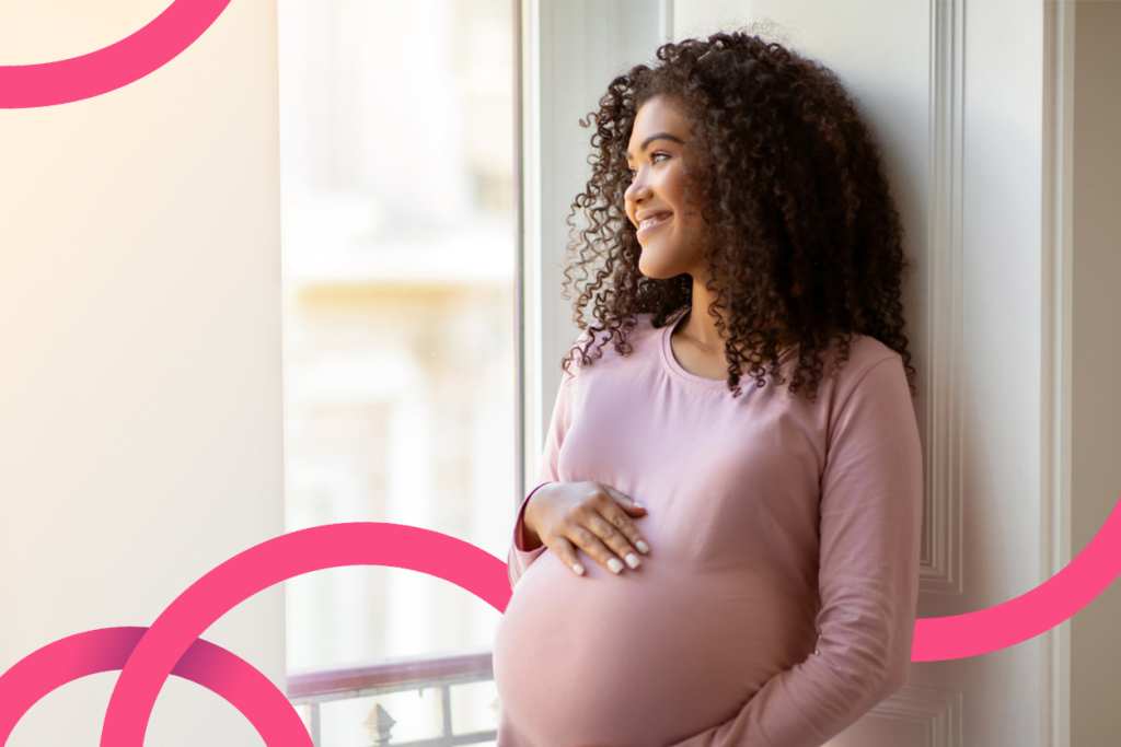 Pregnant woman looking out the window